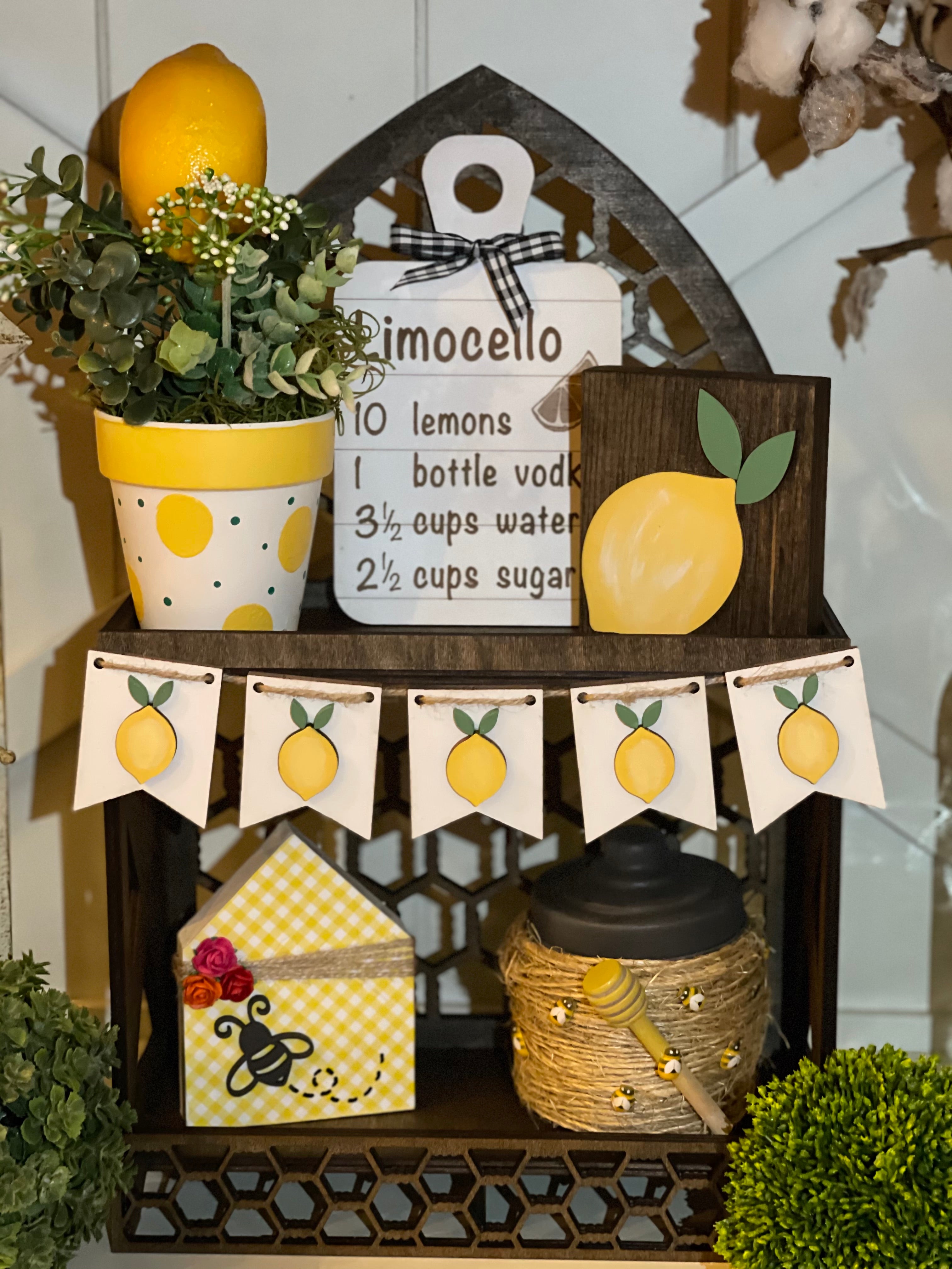 This image shows the cathedral tiered tray with multiple lemon themed decor.  Each item is sold separately on our website.