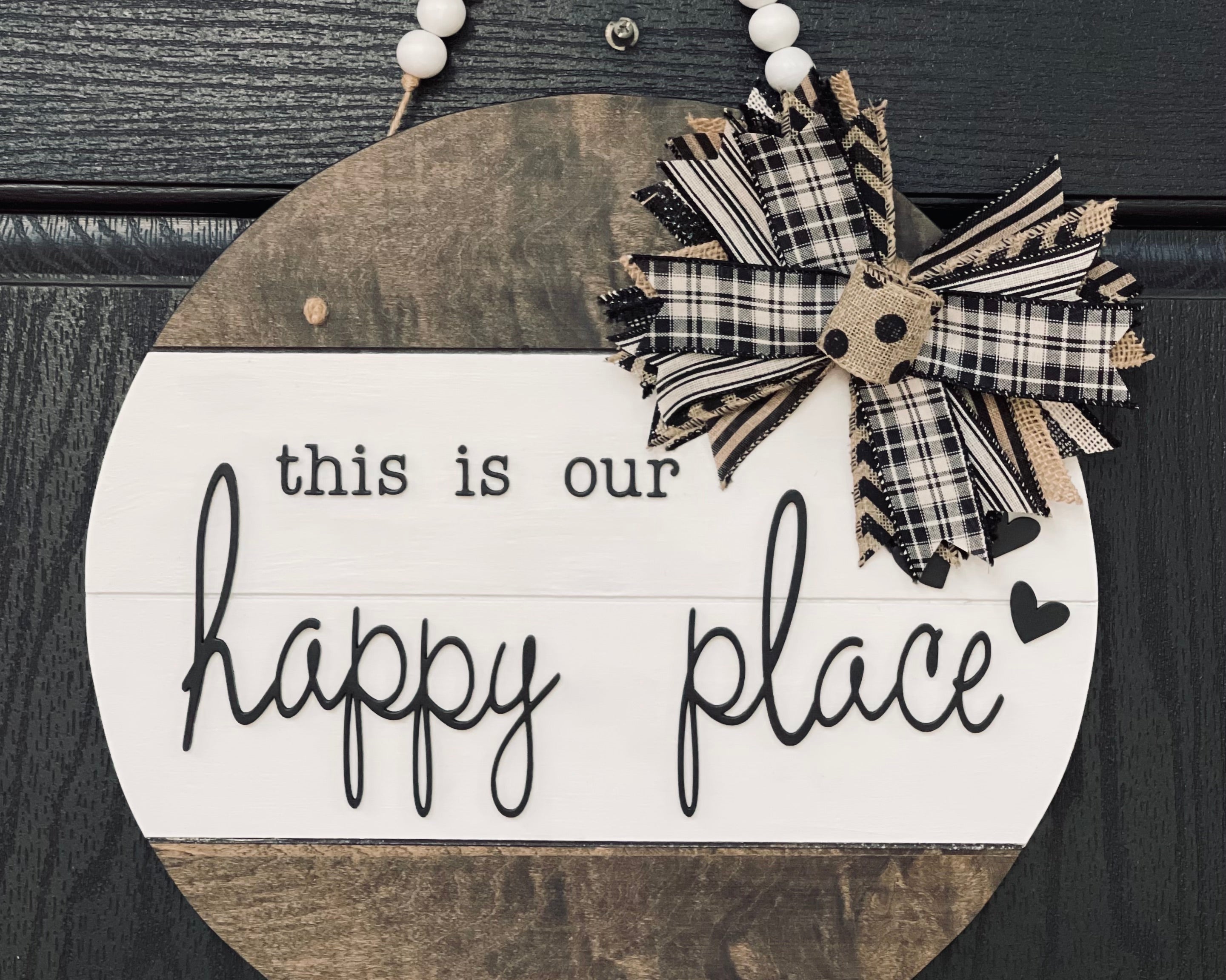 This is Our Happy Place Shiplap Door or Wall Hanger is shown hanging on a front door.  This is the 15" round shown.