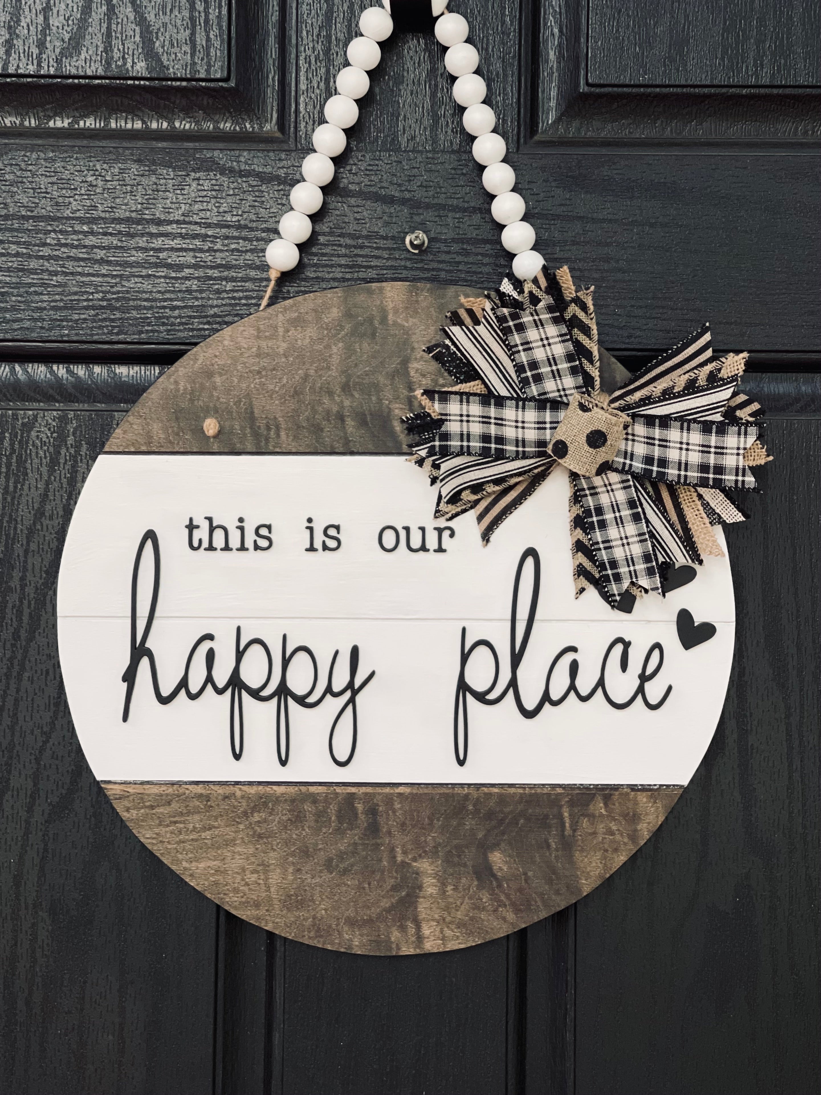 This is Our Happy Place Shiplap Door or Wall Hanger is shown hanging on a front door.  This is the 15" round shown.