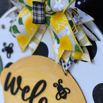 This image shows a close up of the lemon, bee and bow.