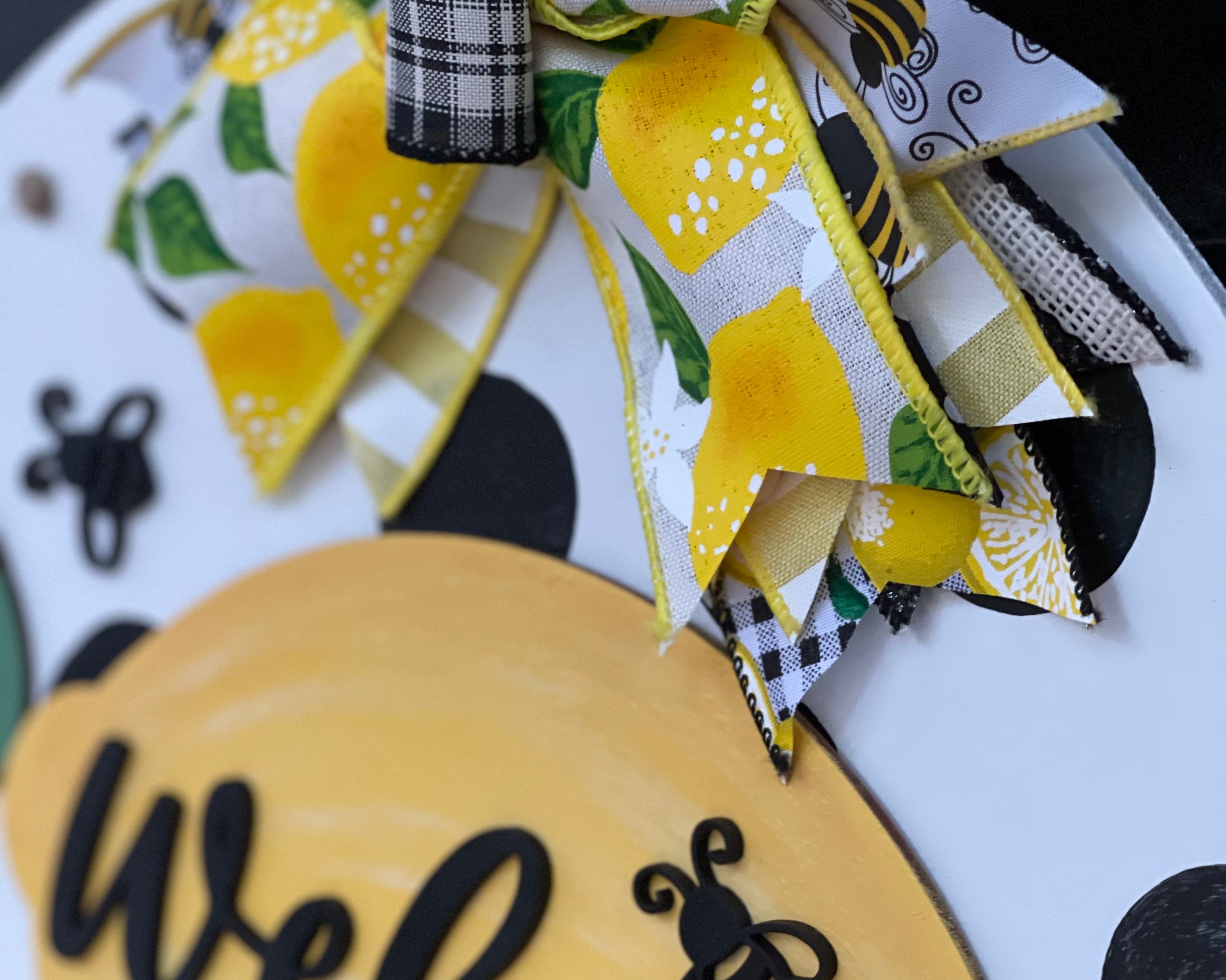 This image shows a close up of the lemon, bee and bow.