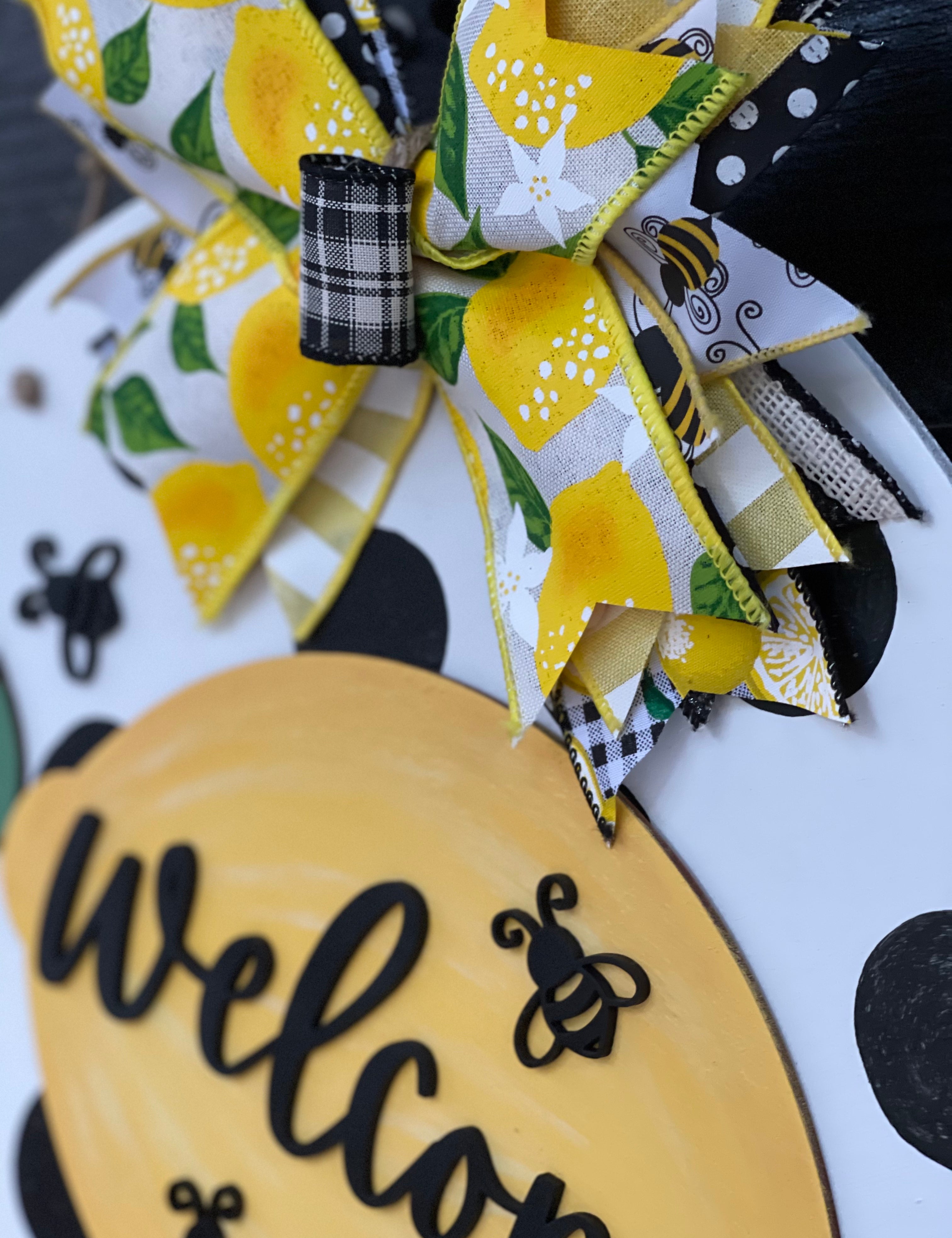 This image shows a close up of the lemon, bee and bow.