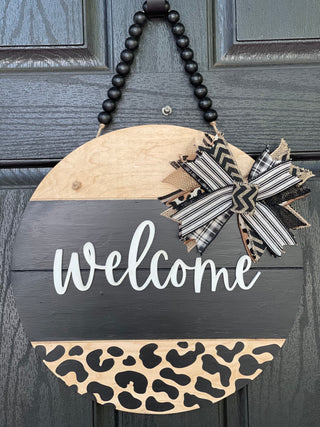 Welcome Shiplap Door or Wall Hanger with Leopard Print shows the 15" round hanging on a front door.